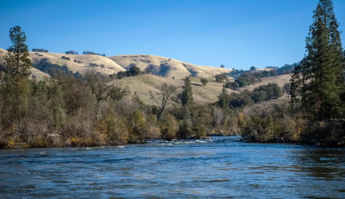 Whitewater and green hills along the American River